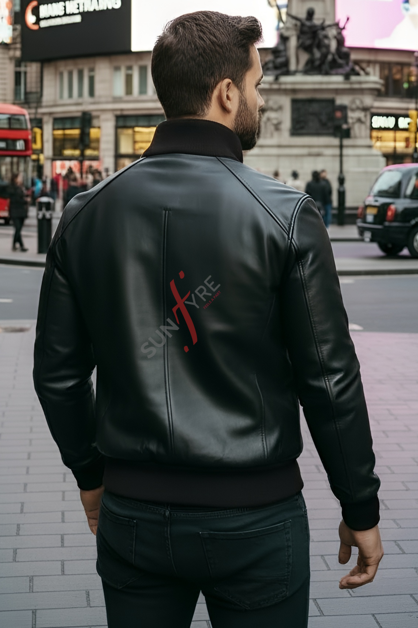 Man wearing a black leather jacket with a brand logo in an urban setting