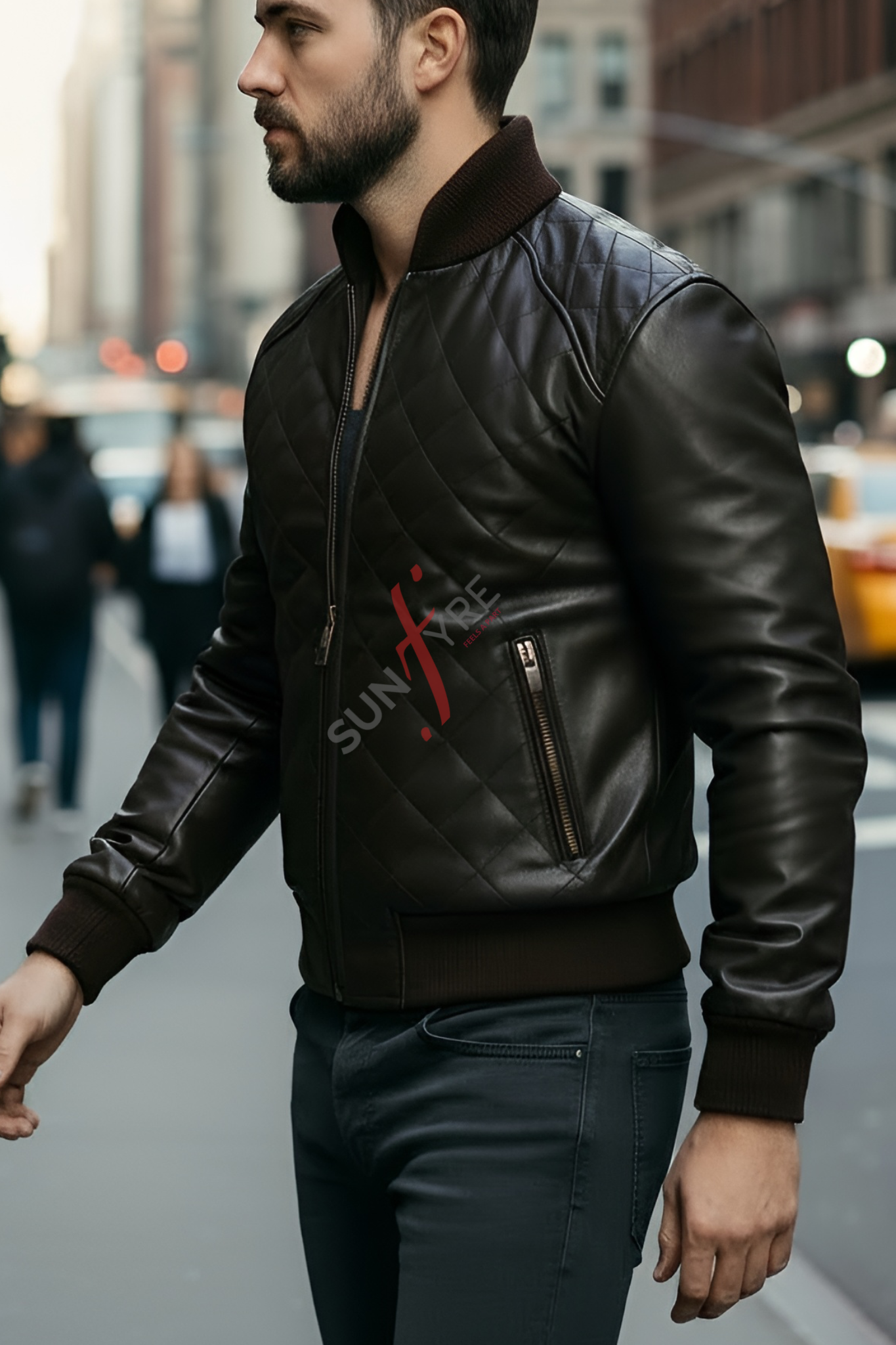 Man wearing a black leather jacket with a brand logo on a city street