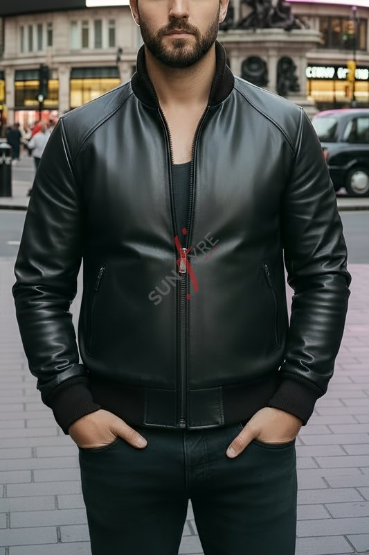 Man wearing a black leather jacket with a red zipper detail, standing on a street.