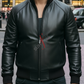 Man wearing a black leather jacket with a red zipper pull on a city street.