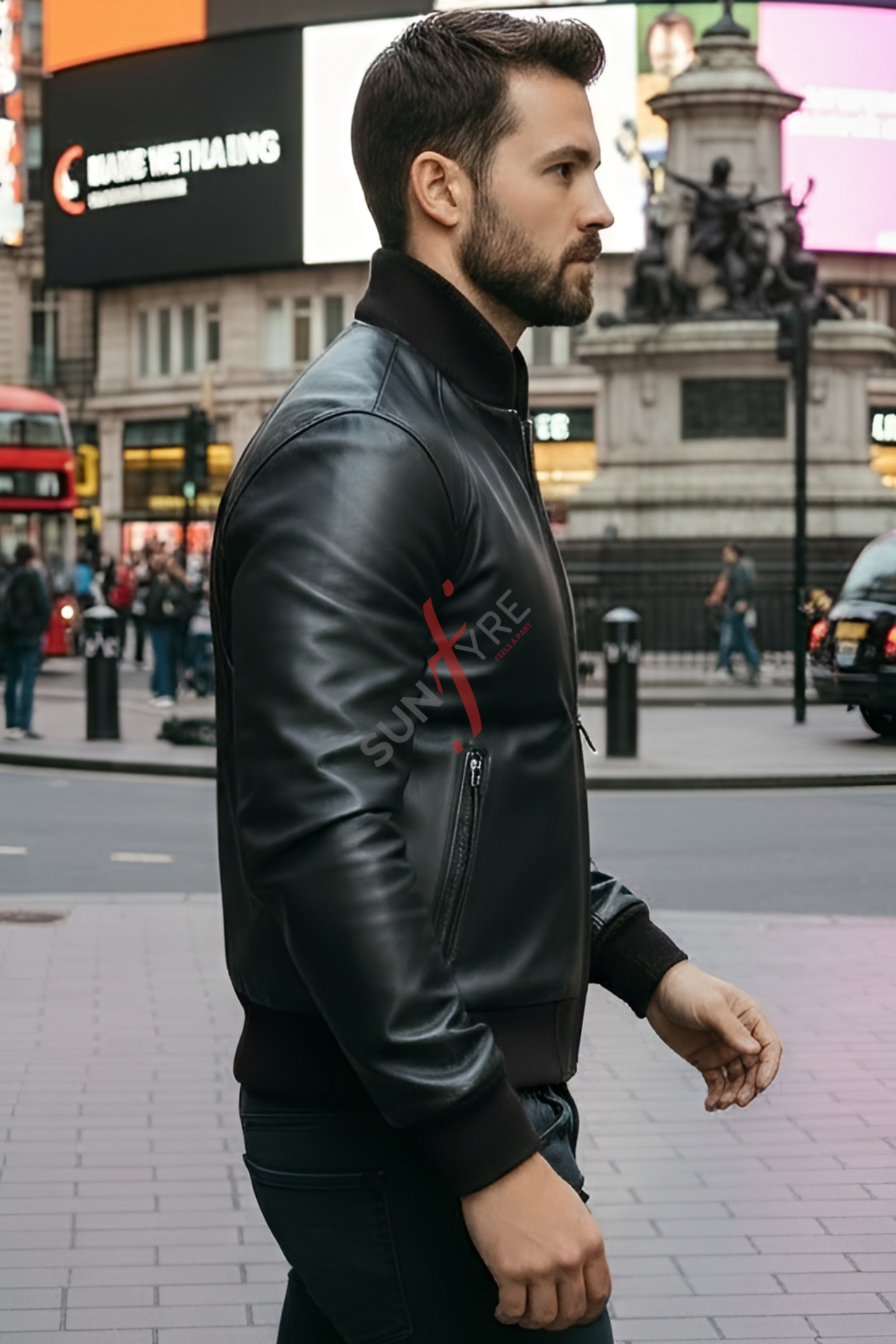 Man wearing a black leather jacket with a brand logo on a city street.