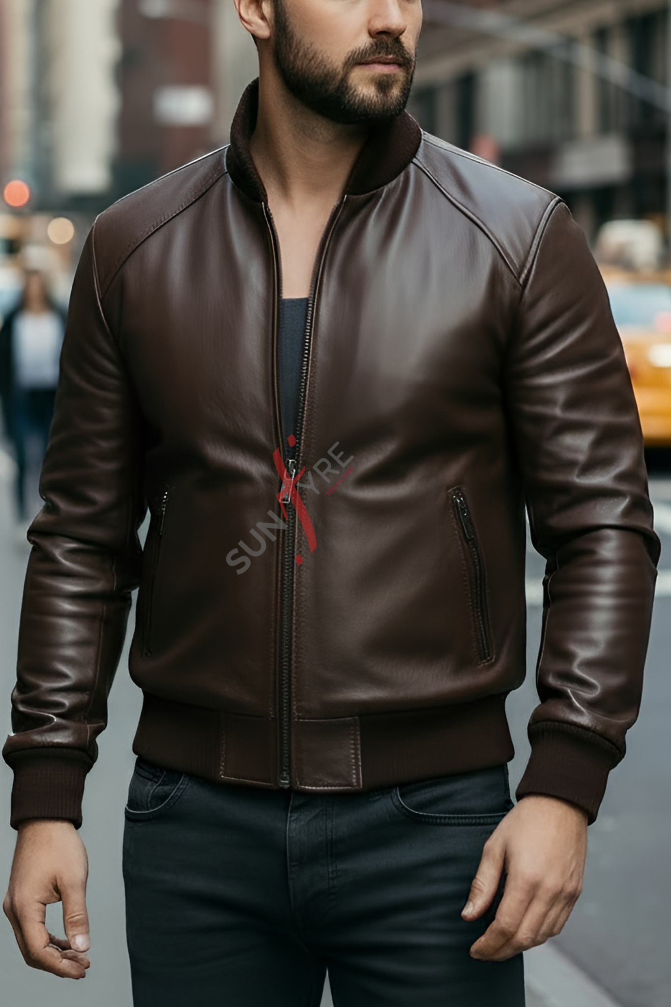 Man wearing a brown leather jacket with a red zipper on a city street.