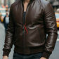 Man wearing a brown leather jacket on a city street