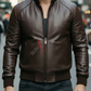 Man wearing a brown leather jacket with a brand logo on a city street.