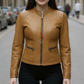 Woman wearing a brown leather jacket on a street background