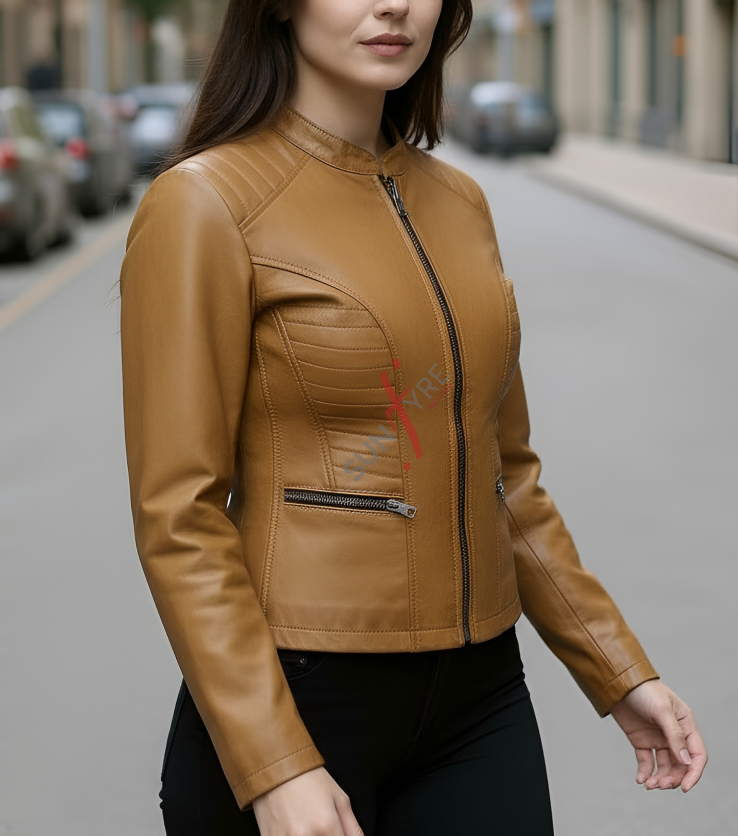 Woman wearing a tan leather jacket on a city street