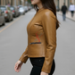 Woman wearing a cognac leather jacket on a city street