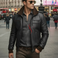 Man wearing a black leather jacket and sunglasses on a city street.