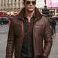 Man wearing a brown leather jacket and sunglasses on a city street