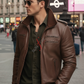 Man wearing a brown leather jacket and sunglasses in an urban setting
