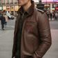 Man wearing a brown leather jacket and sunglasses on a city street.