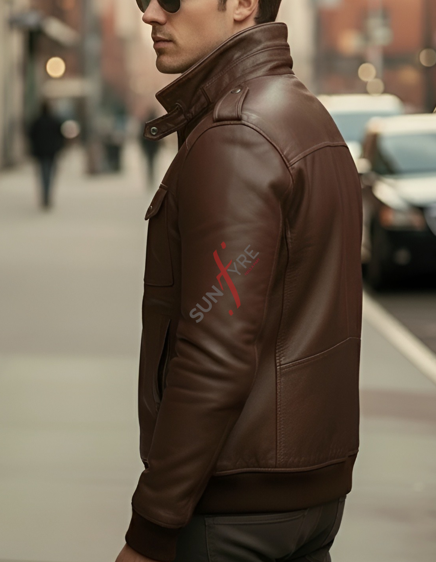Man wearing a brown leather jacket with a brand logo on a blurred street background