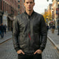 Man wearing a black leather jacket on a city street
