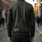 Person wearing a black leather jacket with 'Sunfire' logo on a city street.