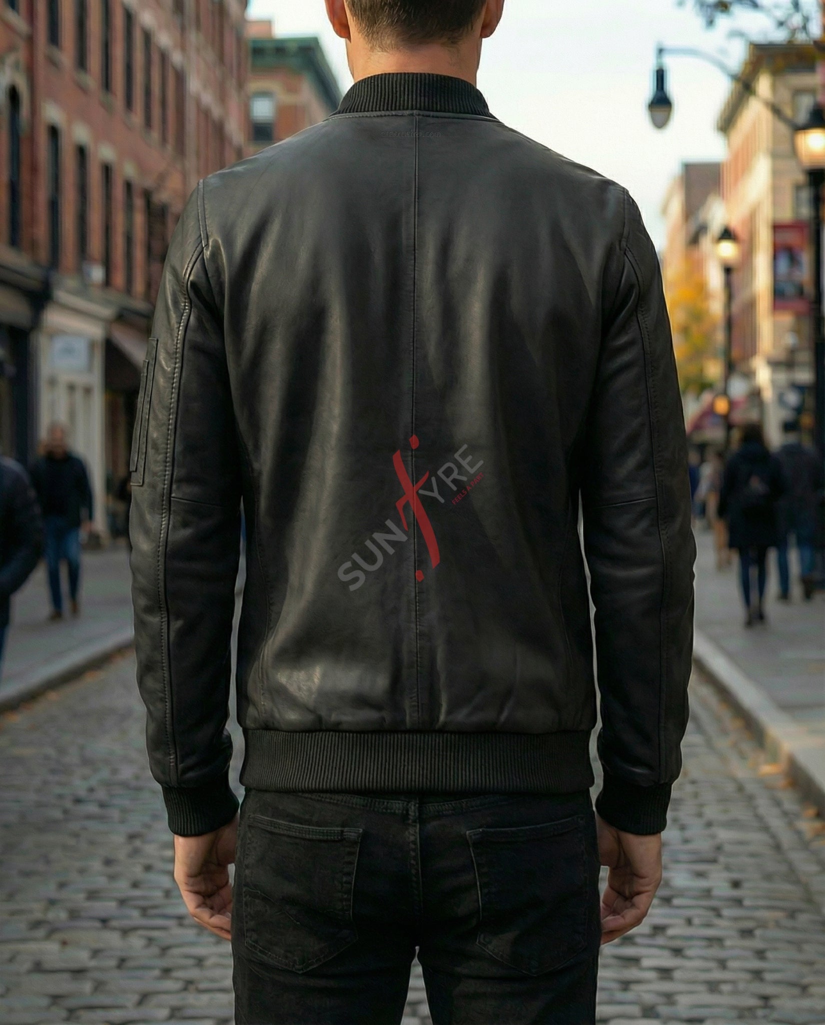 Person wearing a black leather jacket with 'Sunfire' logo on a city street.