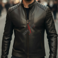 Man wearing a black leather jacket with a brand logo on a blurred street background