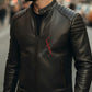 Man wearing a black leather jacket with 'Sunfire' logo on a blurred city street background