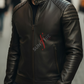 Man wearing a black leather jacket with a brand logo on a blurred street background