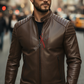 Man wearing a brown leather jacket and sunglasses on a city street.