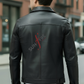 Person wearing a black leather jacket with 'Sunfire' logo on the back, standing on a street.