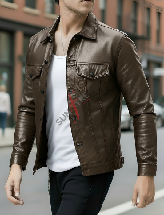Person wearing a brown leather jacket over a white shirt with a red logo, standing on a street.