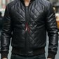 Man wearing a black quilted leather jacket with a blurred city street background