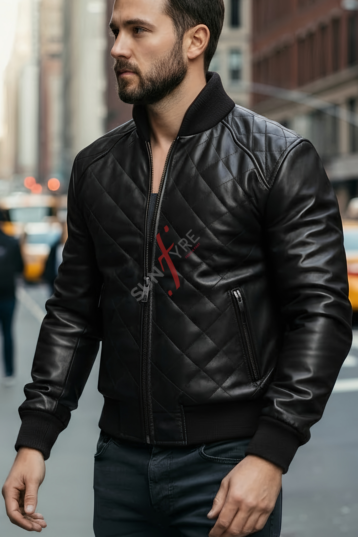 Man wearing a black leather jacket with a brand logo in an urban setting