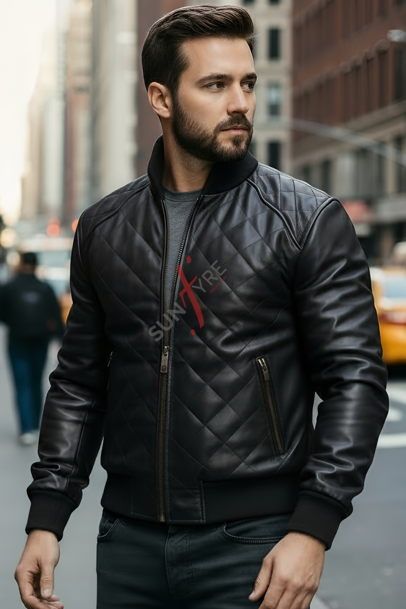 Man wearing a black leather jacket with a brand logo on a city street