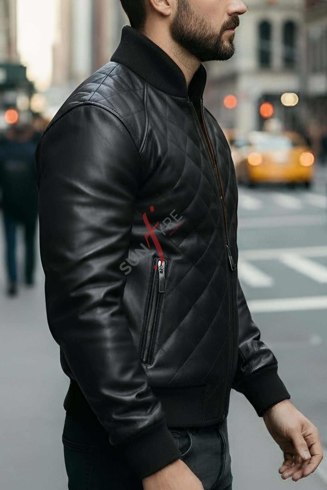 Man wearing a black leather jacket with a brand logo on a city street