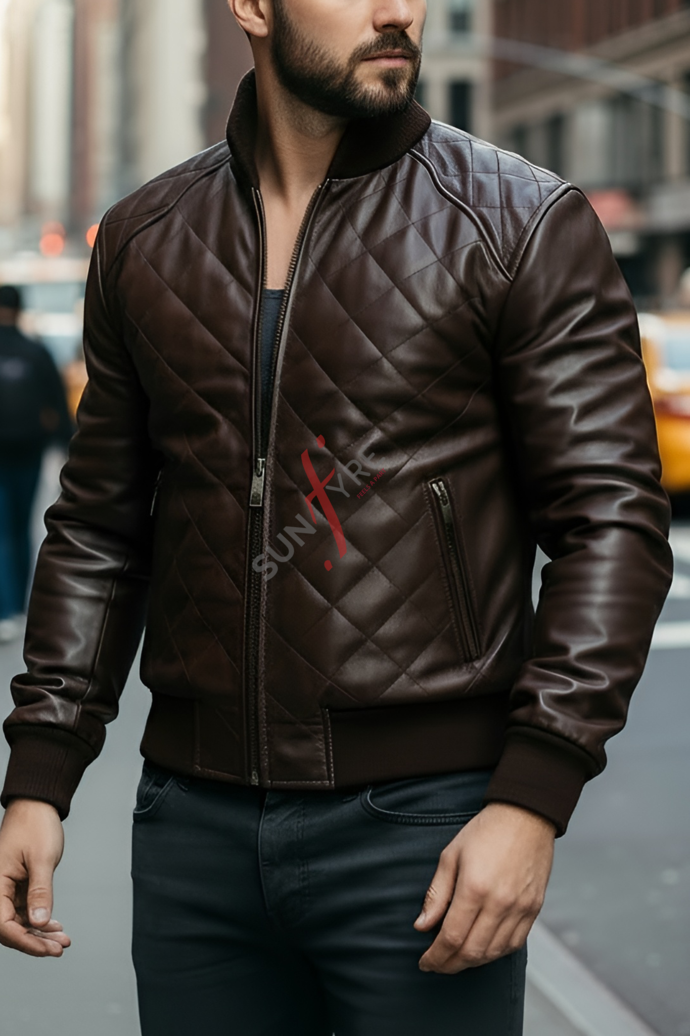 Man wearing a brown leather jacket with a brand logo on a city street.