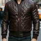 Man wearing a brown quilted leather jacket on a city street.