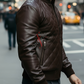 Man wearing a brown leather jacket on a city street