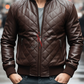 Man wearing a brown quilted leather jacket on a blurred city street background