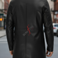 Person wearing a black leather coat with 'SUNFIRE' branding on a city street.