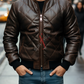 Man wearing a brown leather jacket on a city street
