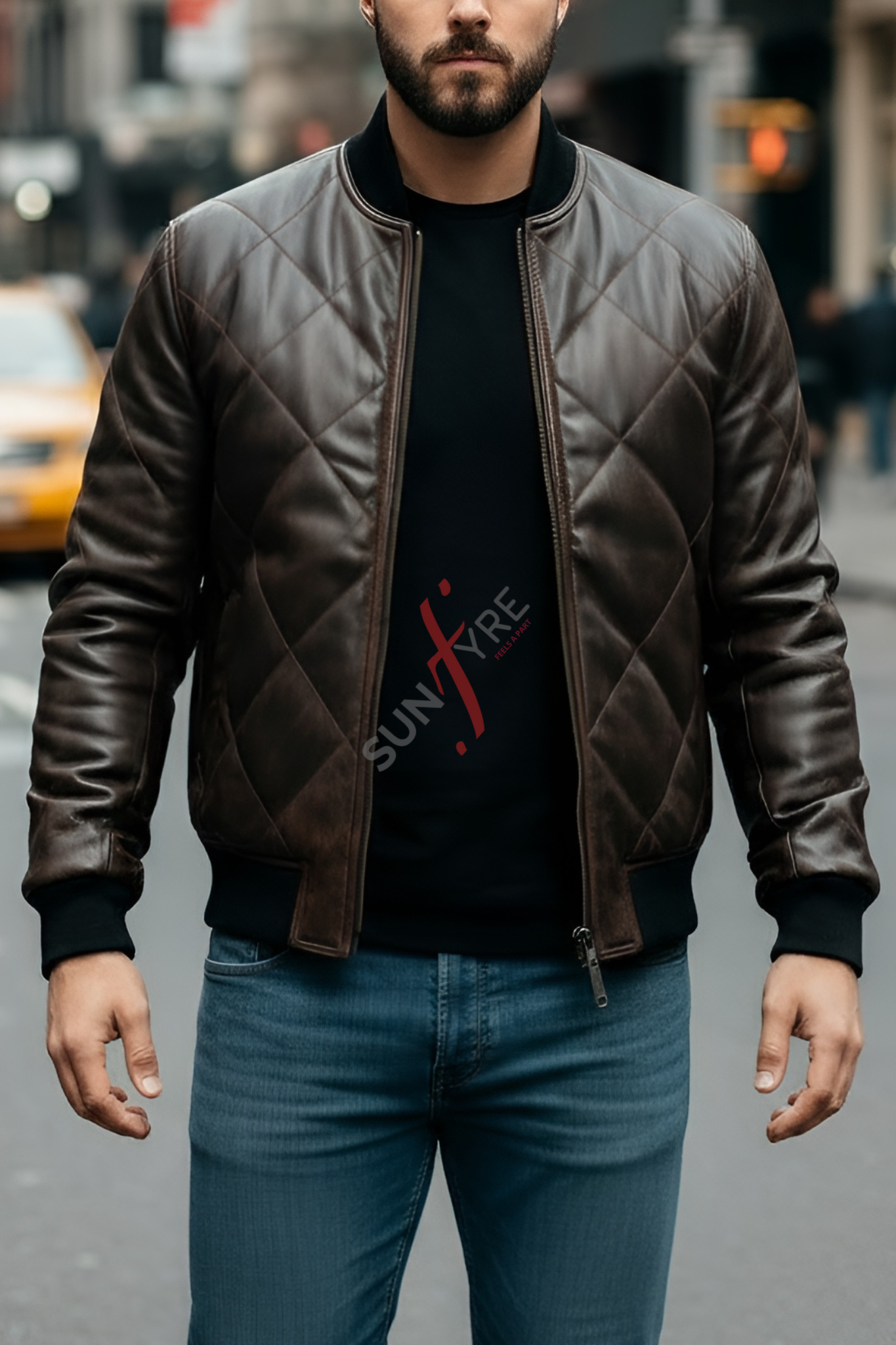 Man wearing a brown leather jacket and black t-shirt with 'SUNFIRE' logo on a city street.