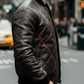 Man wearing a brown leather jacket with 'Suntory' branding on a city street.