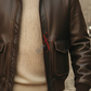 Brown leather jacket over a beige sweater with a blurred background