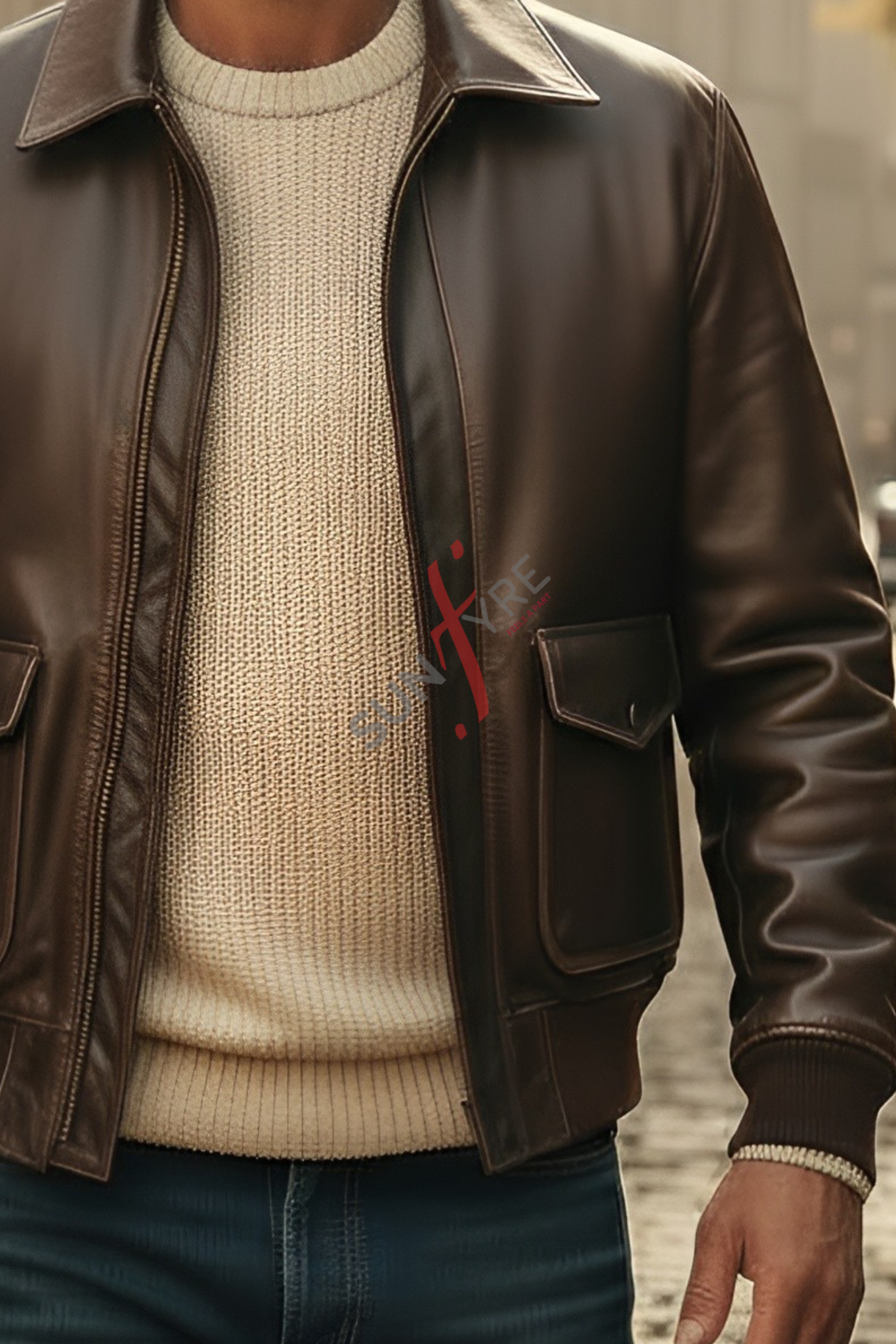 Brown leather jacket over a beige sweater with a blurred background