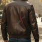 Man wearing a brown leather jacket with 'Sunray' logo on the back, walking in an urban setting.