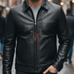 Man wearing a black leather jacket with a brand logo on a blurred street background