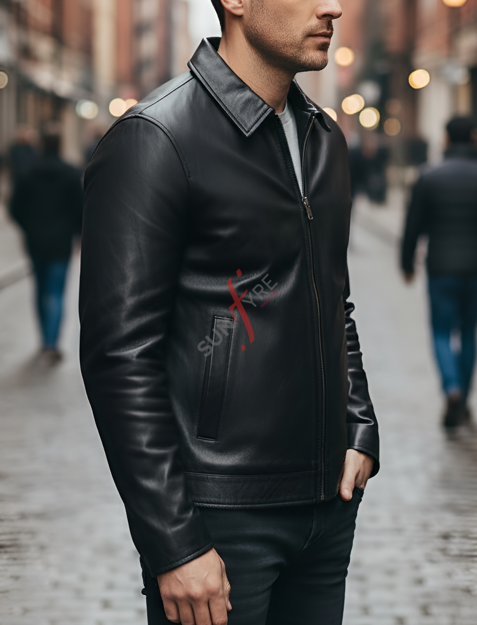 Man wearing a black leather jacket with a brand logo on a blurred street background