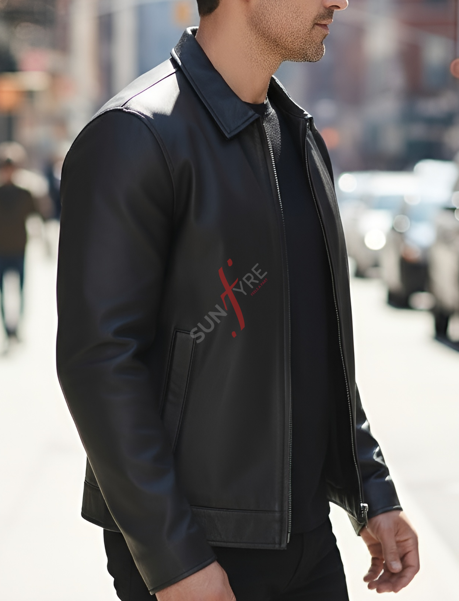 Man wearing a black jacket with 'Suntire' logo on a city street