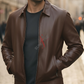Man wearing a brown leather jacket on a blurred street background