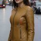 Woman wearing a tan leather jacket on a city street